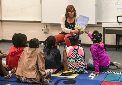 Spark instructor reading to students
